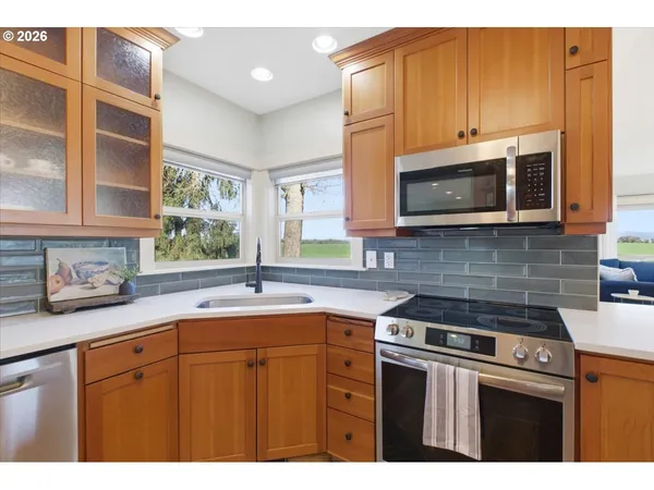 a kitchen with stainless steel appliances a sink stove and microwave