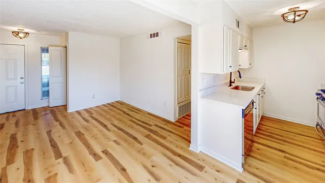 a view of a bedroom with a sink and storage
