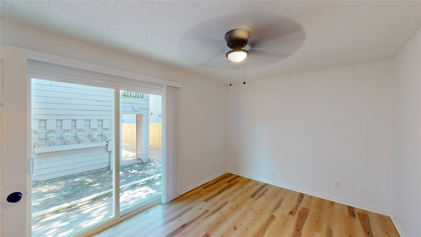 2707 Windswept Cove, Unit 102 Austin, TX 78745 - Photo 8 of 12 a view of empty room with wooden floor and fan