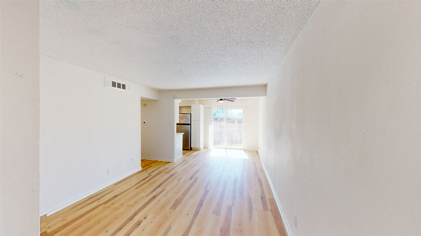 2707 Windswept Cove, Unit 102 Austin, TX 78745 - Photo 10 of 12 a view of a hallway with wooden floor