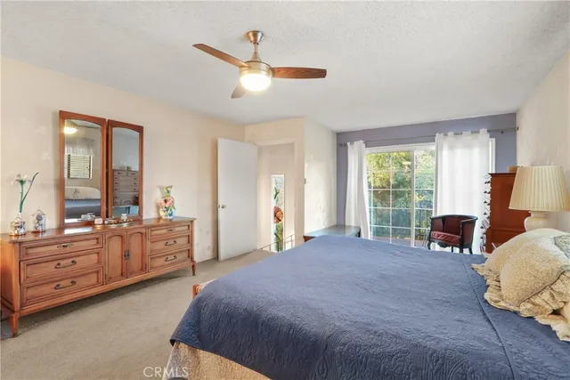 a large bedroom with a bed and large windows