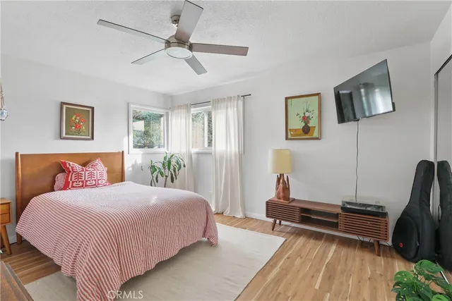 a bedroom with a bed and wooden floor