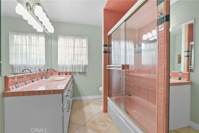 a bathroom with a tub sink and mirror