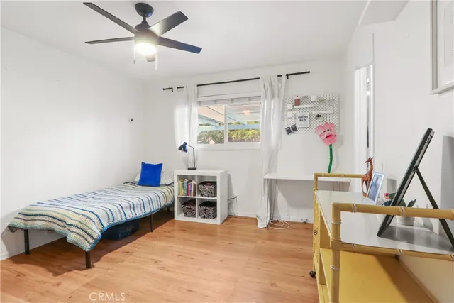 a bedroom with a bed furniture and a large window