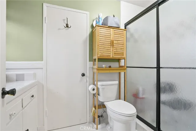 a white toilet sitting next to a bathroom sink