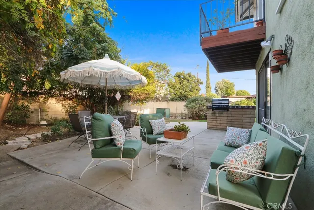 a backyard of a house with table and chairs