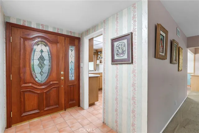 a view of a hallway with entryway wooden floor and front door