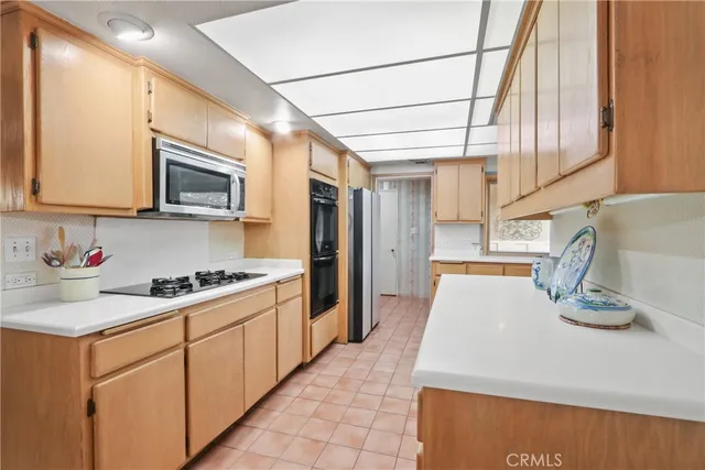 a kitchen with stainless steel appliances granite countertop a sink a stove and cabinets