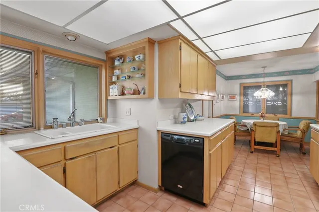a kitchen with a stove sink and cabinets