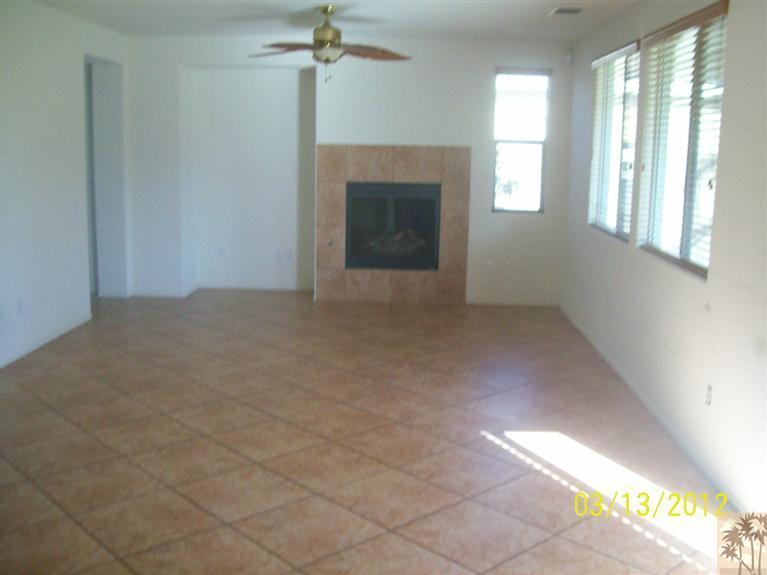 83401 Lone Star Road Indio, CA 92203 - Photo 4 of 10 an empty room with windows and fireplace