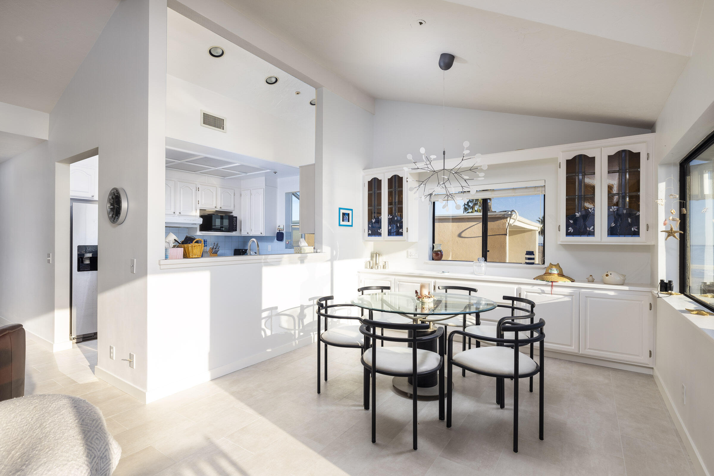 4925 Sandyland Road, Unit F Carpinteria, CA 93013 - Photo 7 of 19 a kitchen with stainless steel appliances kitchen island granite countertop a table and chairs in it