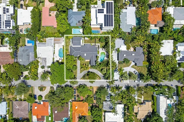 an aerial view of multiple houses with yard