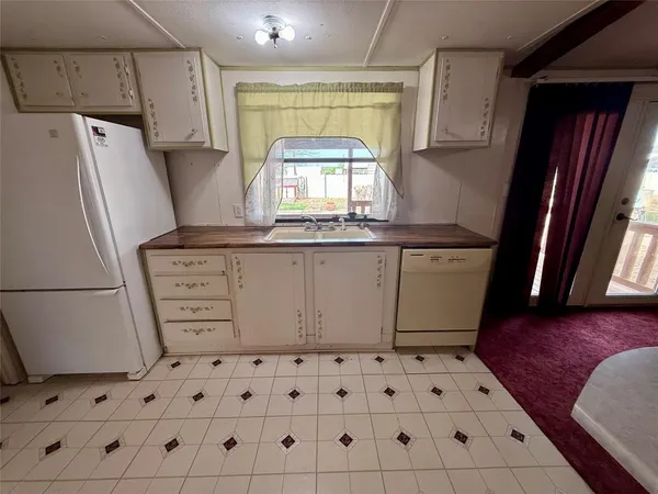 a kitchen with a sink a stove and refrigerator