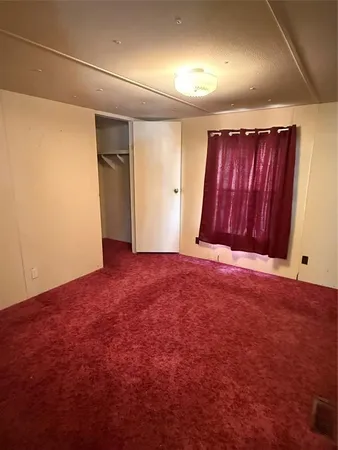an empty room with wooden floor and entrance