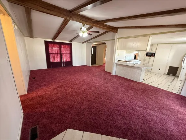 a large white kitchen with sink and refrigerator