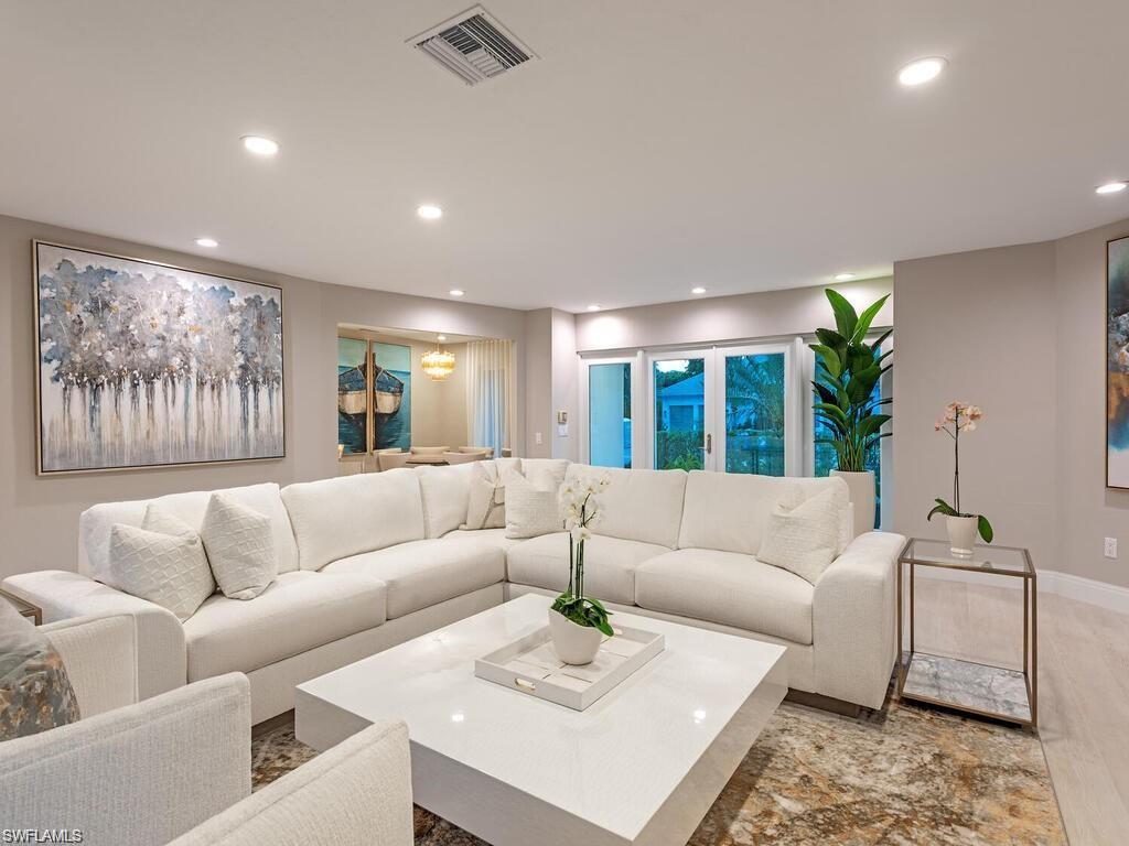 4856 Crayton Road Naples, FL 34103 - Photo 11 of 24 a living room with furniture and a large window