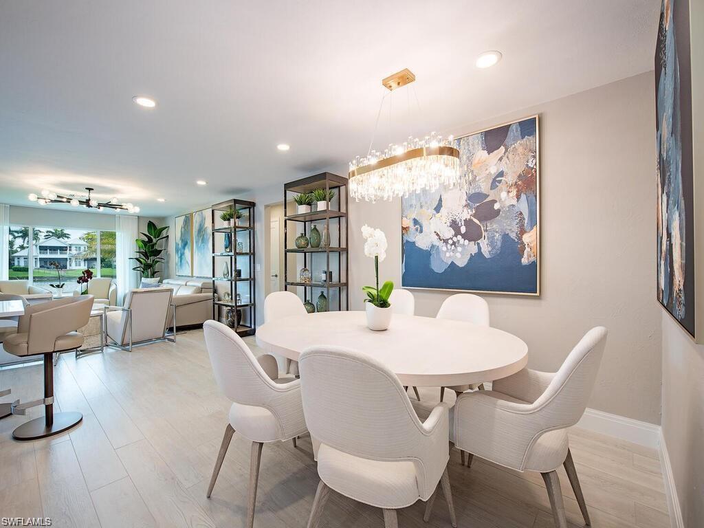 4856 Crayton Road Naples, FL 34103 - Photo 12 of 24 a view of a dining room with furniture window and wooden floor