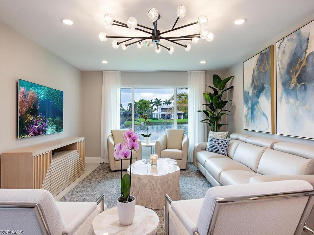 4856 Crayton Road Naples, FL 34103 - Photo 15 of 24 a living room with furniture and a large window