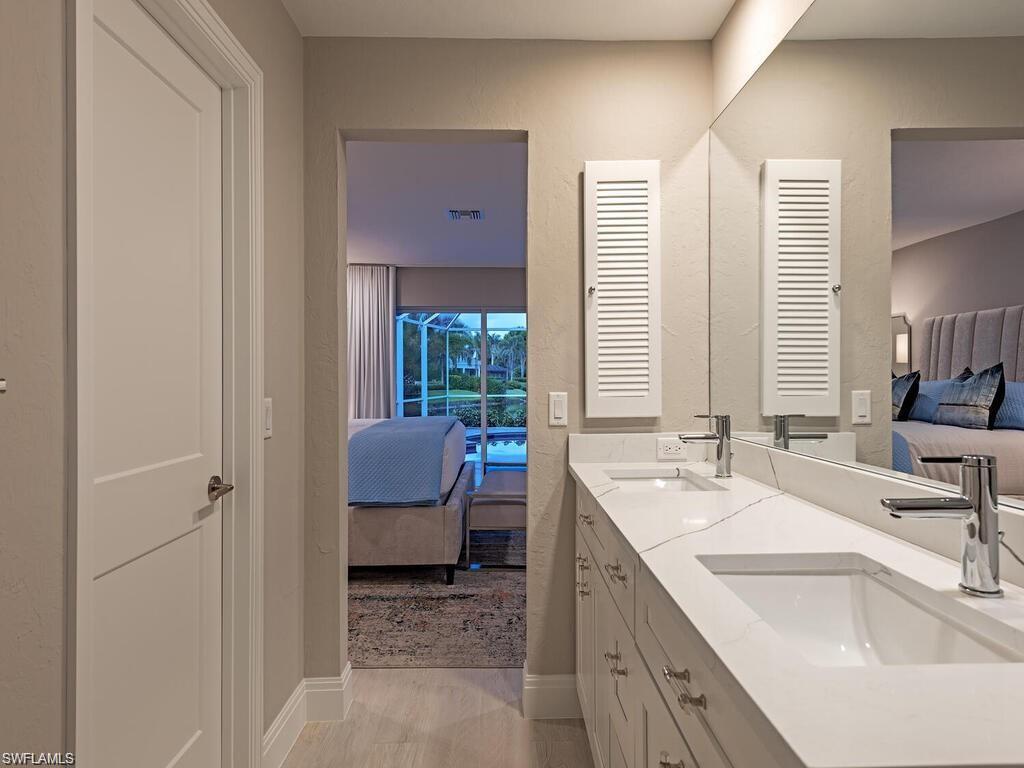 4856 Crayton Road Naples, FL 34103 - Photo 17 of 24 a bathroom with a sink double vanity and a bathtub