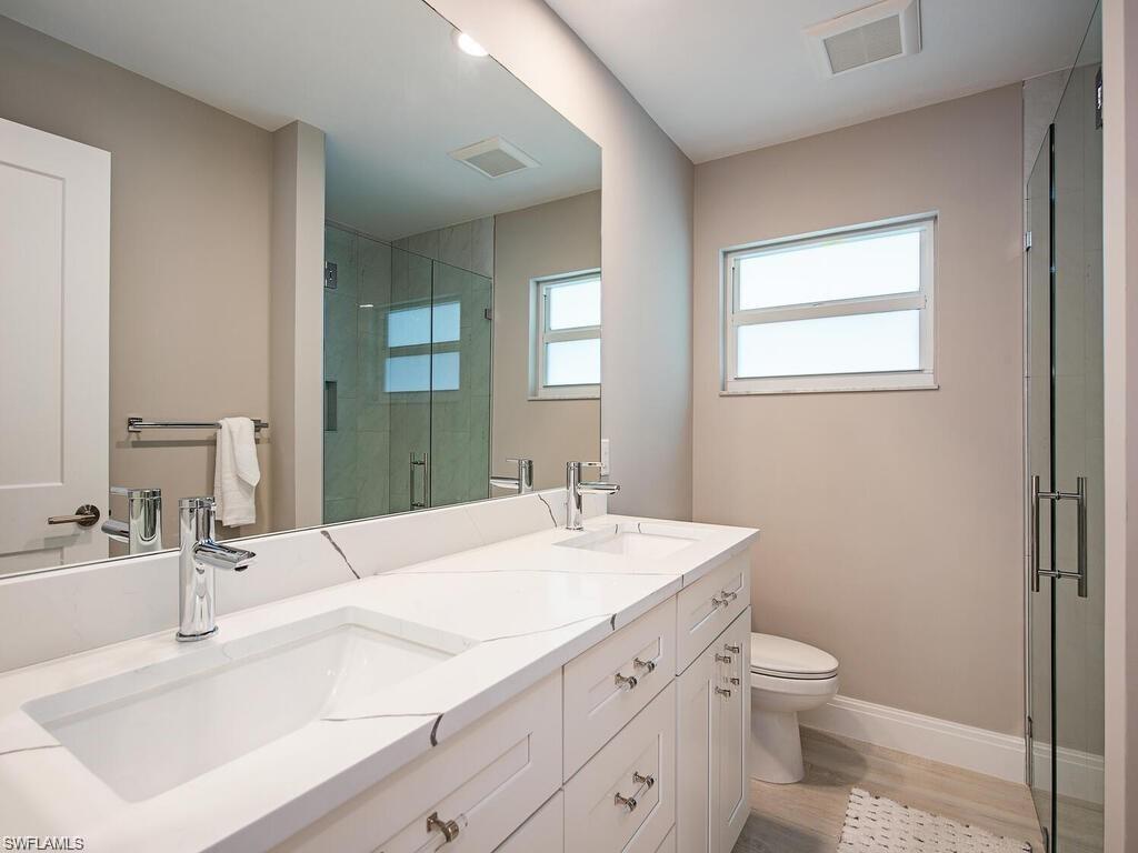 4856 Crayton Road Naples, FL 34103 - Photo 19 of 24 a bathroom with a sink and a toilet