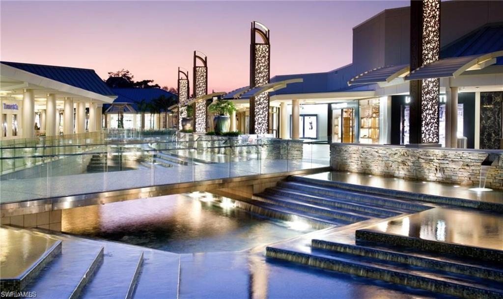 4856 Crayton Road Naples, FL 34103 - Photo 22 of 24 a view of a swimming pool with outdoor seating