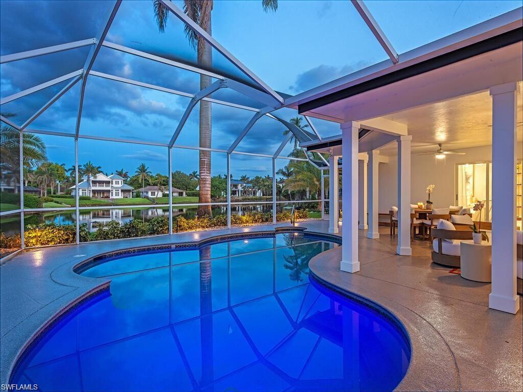 4856 Crayton Road Naples, FL 34103 - Photo 6 of 24 a view of a kitchen with dining table and chairs