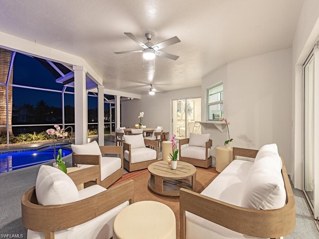 4856 Crayton Road Naples, FL 34103 - Photo 7 of 24 a living room with furniture and a flat screen tv