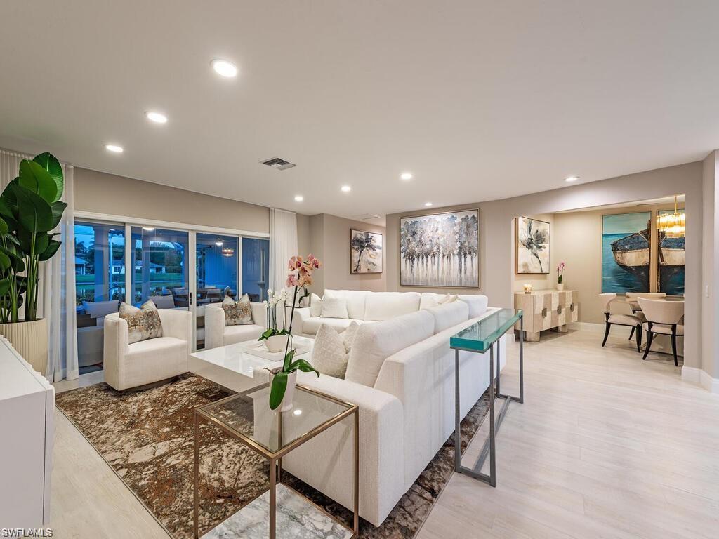 4856 Crayton Road Naples, FL 34103 - Photo 8 of 24 a living room with fireplace furniture and a table