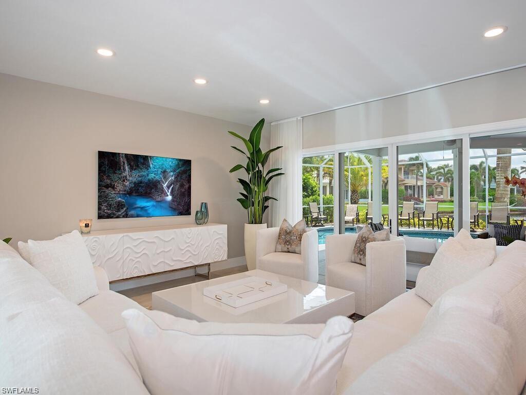 4856 Crayton Road Naples, FL 34103 - Photo 9 of 24 a living room with furniture and a large window
