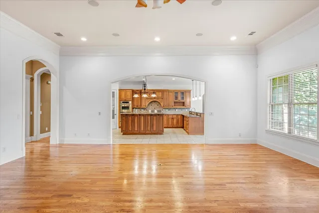 a kitchen with granite countertop a sink and dishwasher with wooden floor