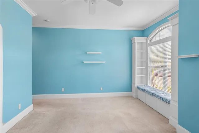 an empty room with a ceiling fan and a window