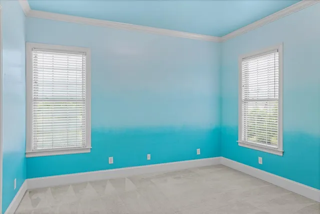 an empty room with a window and a ceiling fan