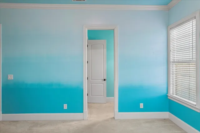 an empty room with closet and a chandelier fan