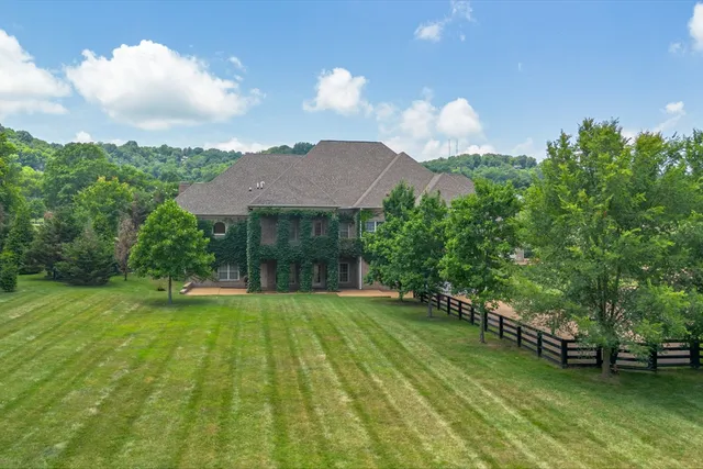 a view of a house with a yard and sitting area
