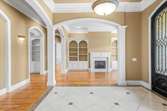 a view of a big room with wooden floor and chandelier