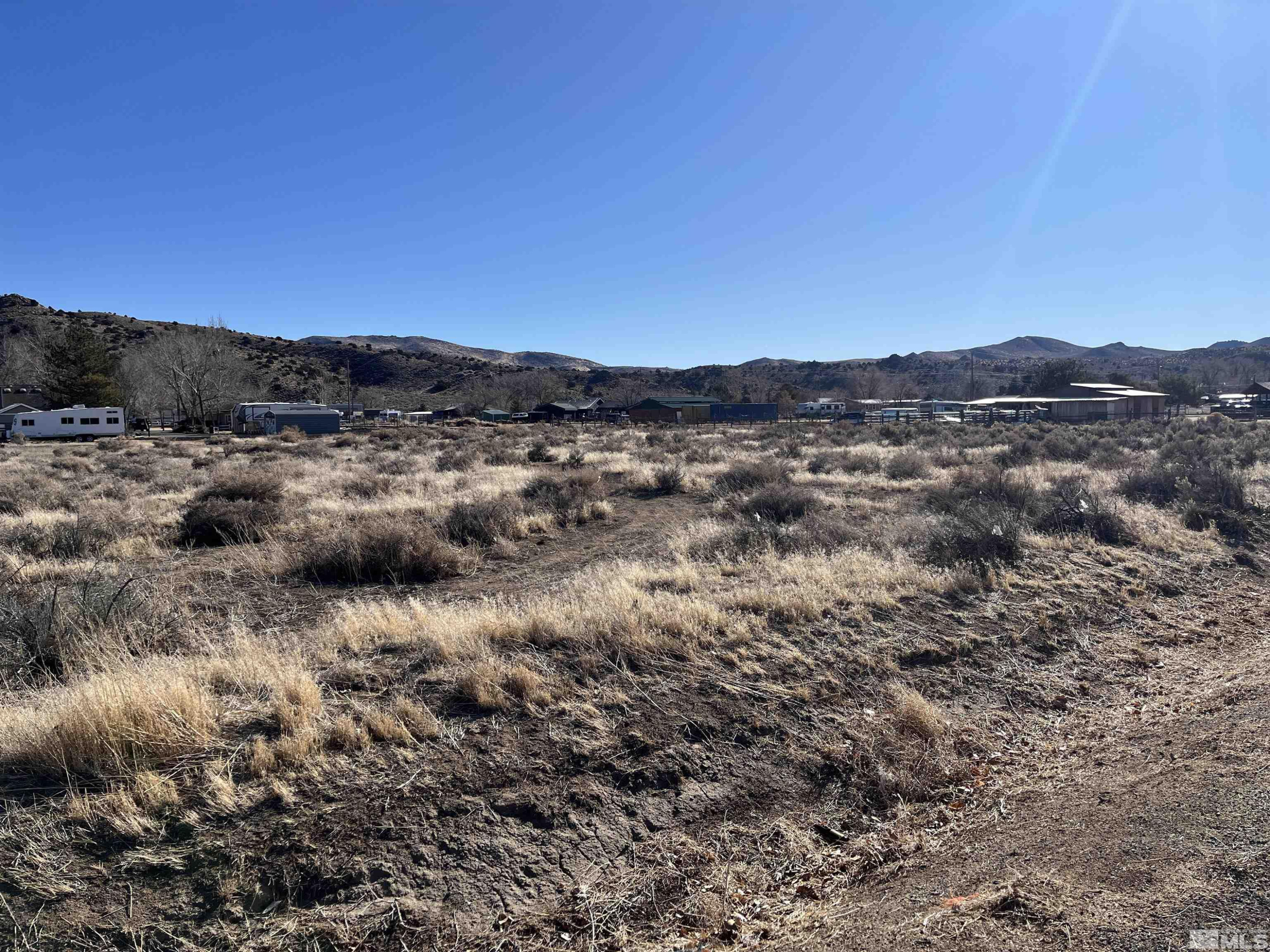 11060 Chestnut Street Reno, NV 89506 - Photo 2 of 3 a view of a dry field with mountains in the background