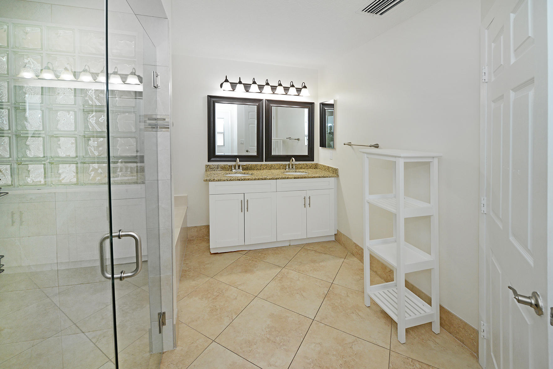 9513 Lake Serena Drive Boca Raton, FL 33496 - Photo 17 of 26 a room with a mirror and a shower