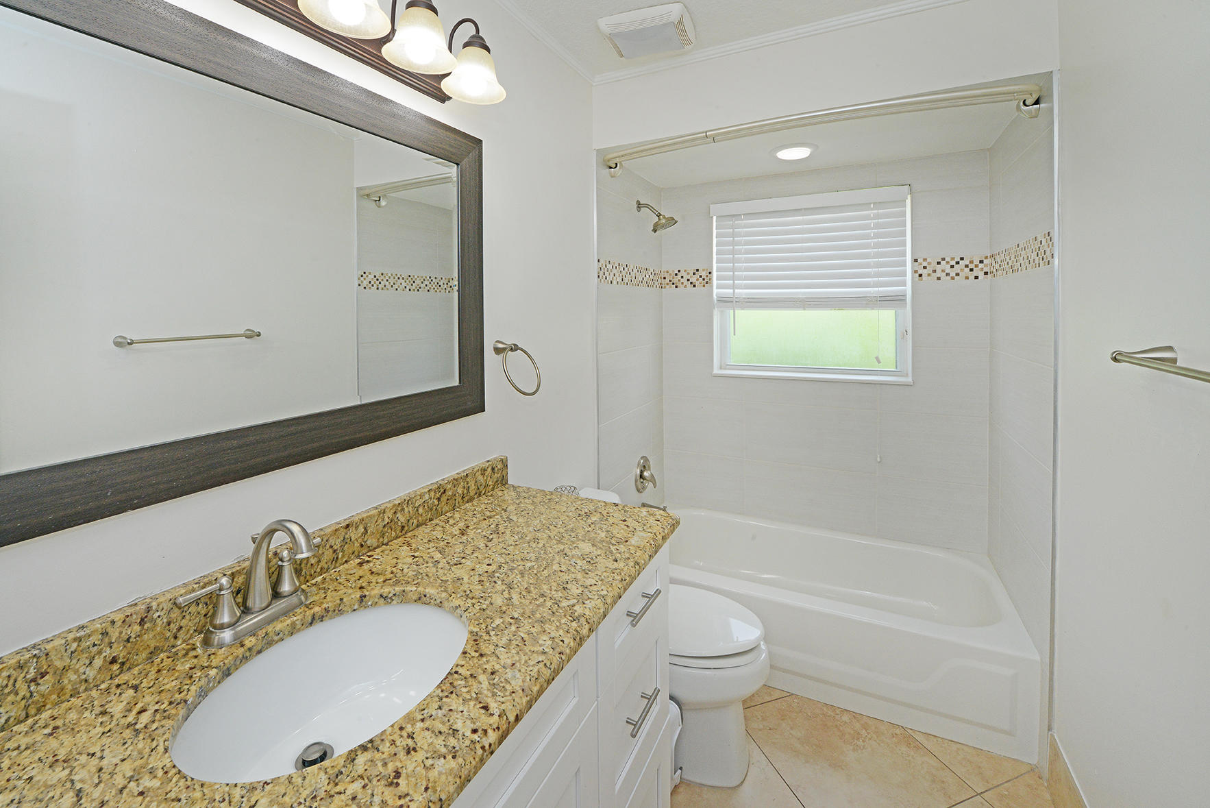9513 Lake Serena Drive Boca Raton, FL 33496 - Photo 18 of 26 a bathroom with a granite countertop sink mirror vanity bathtub and a toilet