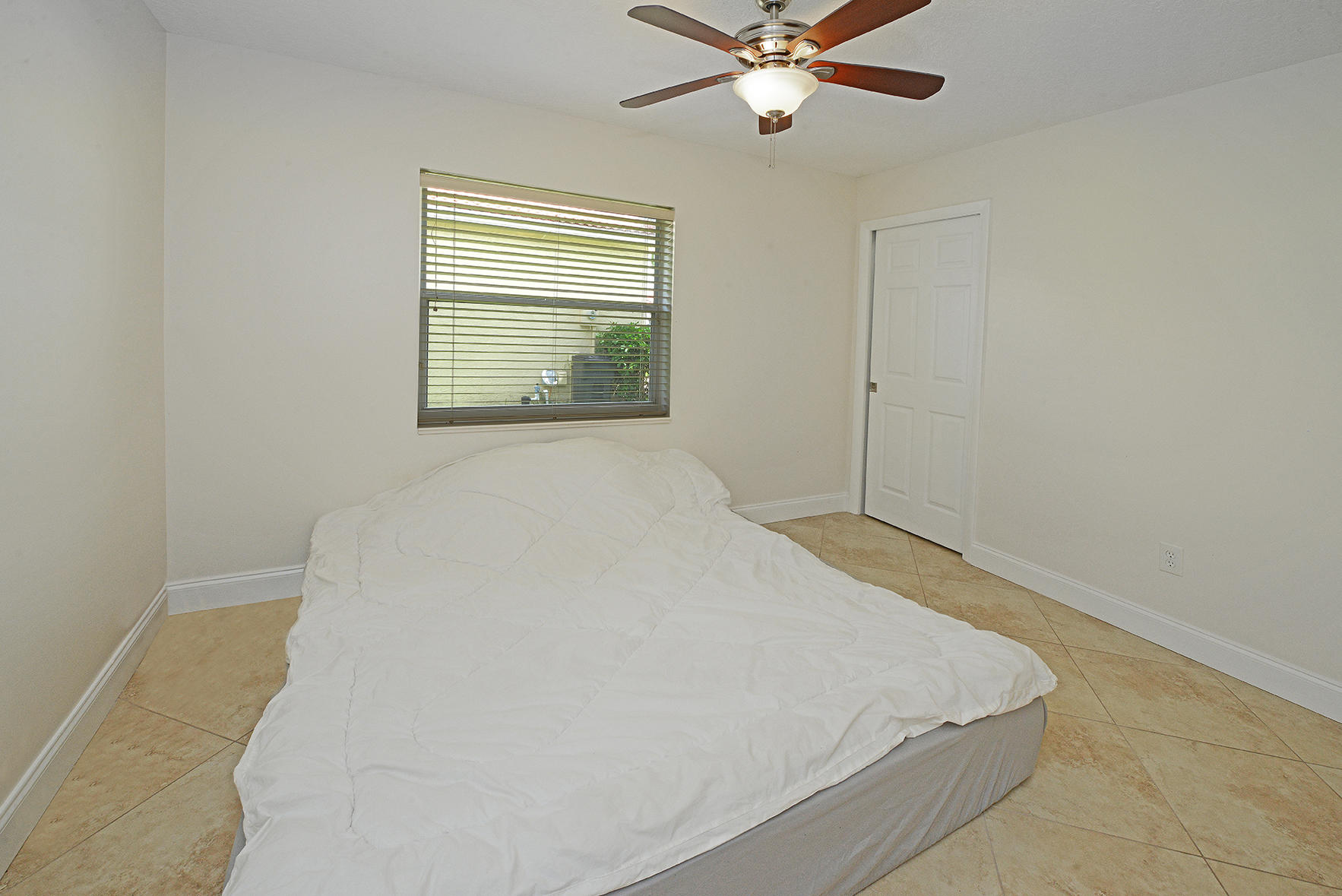 9513 Lake Serena Drive Boca Raton, FL 33496 - Photo 19 of 26 a bed room with a bed and a window