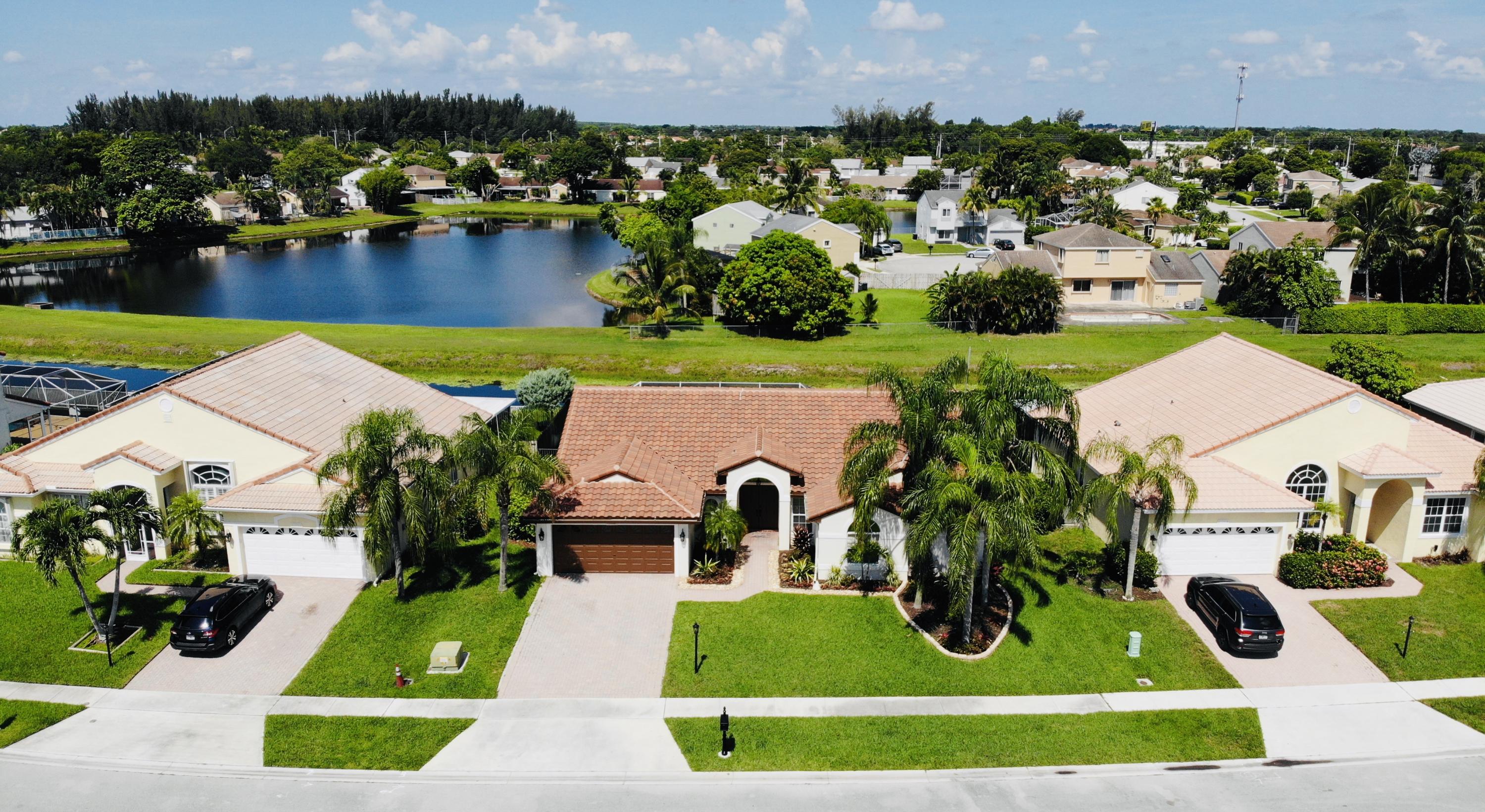 9513 Lake Serena Drive Boca Raton, FL 33496 - Photo 2 of 26 an aerial view of a house with outdoor space swimming pool and lake view