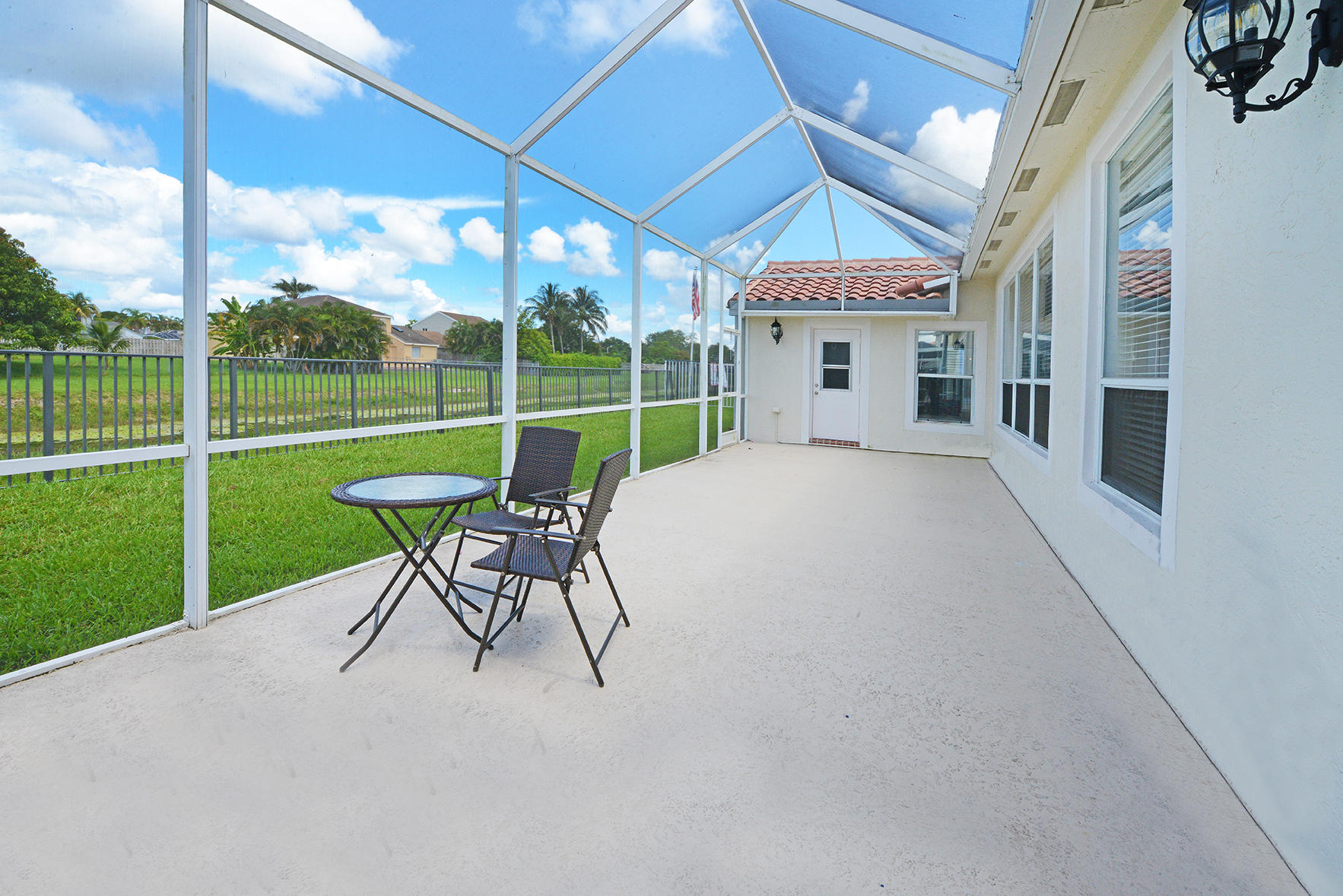 9513 Lake Serena Drive Boca Raton, FL 33496 - Photo 21 of 26 a view of a chairs and a tables in the patio