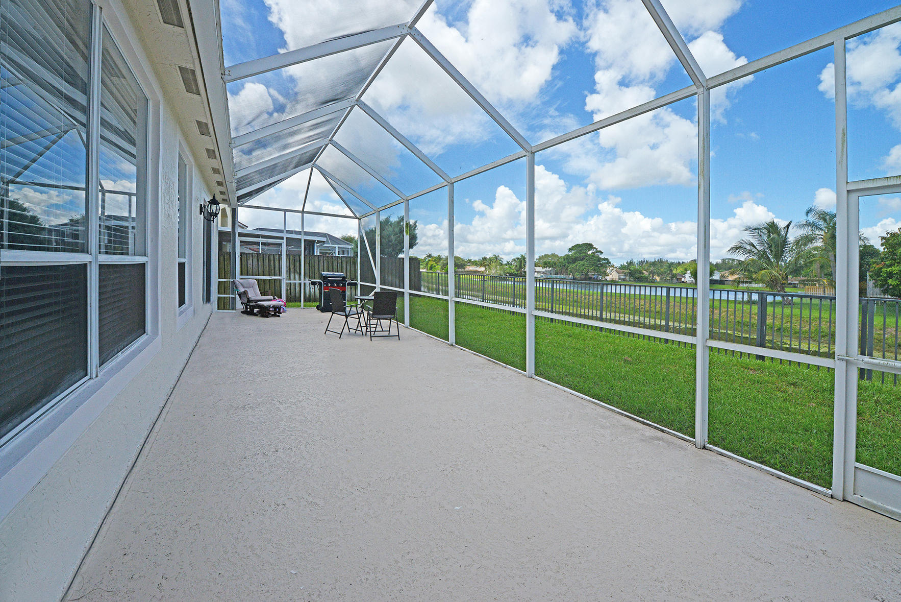9513 Lake Serena Drive Boca Raton, FL 33496 - Photo 22 of 26 a view of a house with a big yard and potted plants