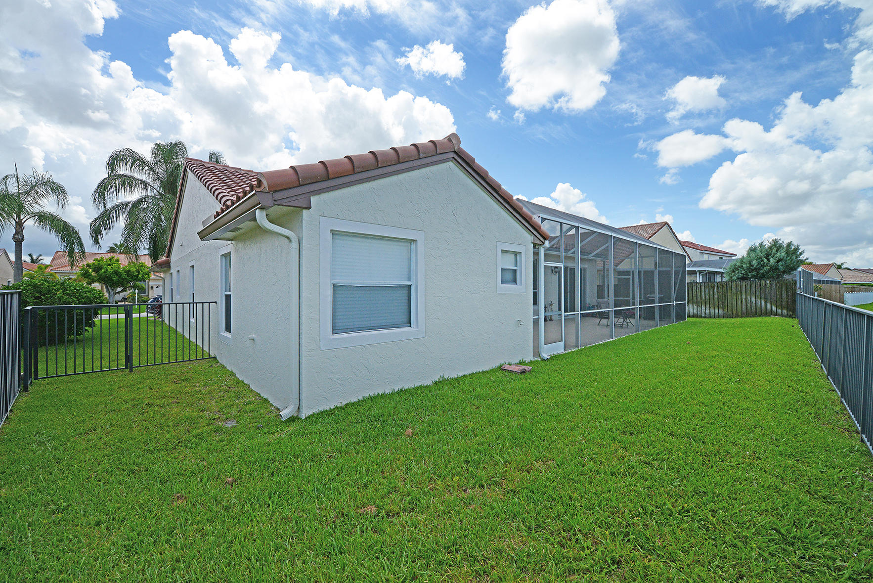 9513 Lake Serena Drive Boca Raton, FL 33496 - Photo 23 of 26 a view of a house with a big yard and a fountain