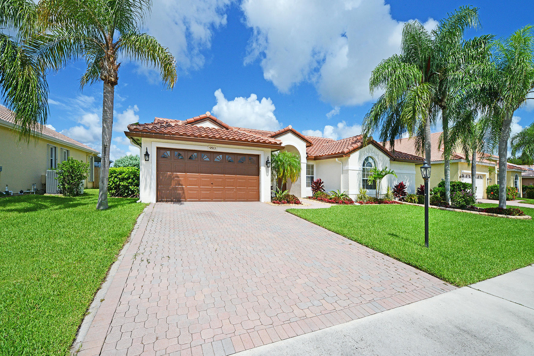 9513 Lake Serena Drive Boca Raton, FL 33496 - Photo 3 of 26 a front view of house with yard and green space