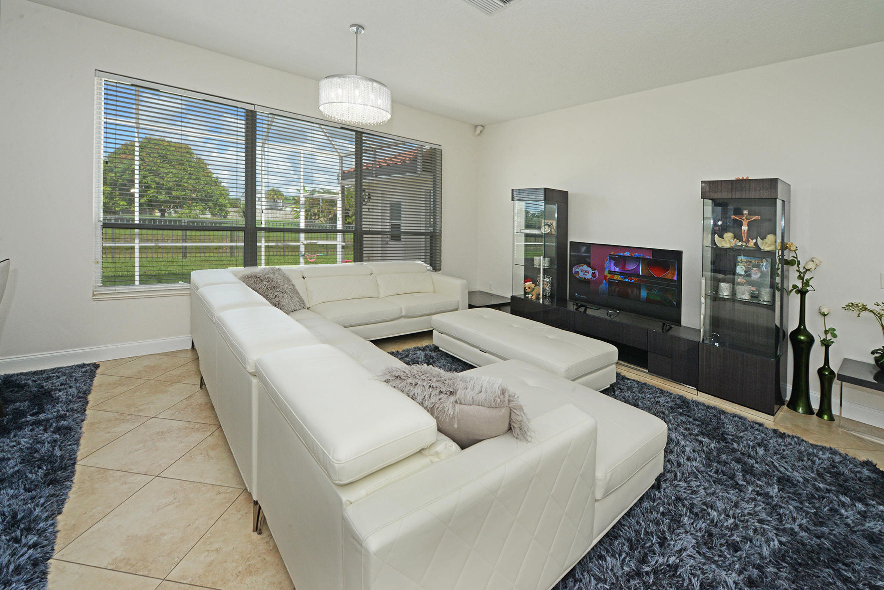 9513 Lake Serena Drive Boca Raton, FL 33496 - Photo 6 of 26 a living room with furniture and a flat screen tv