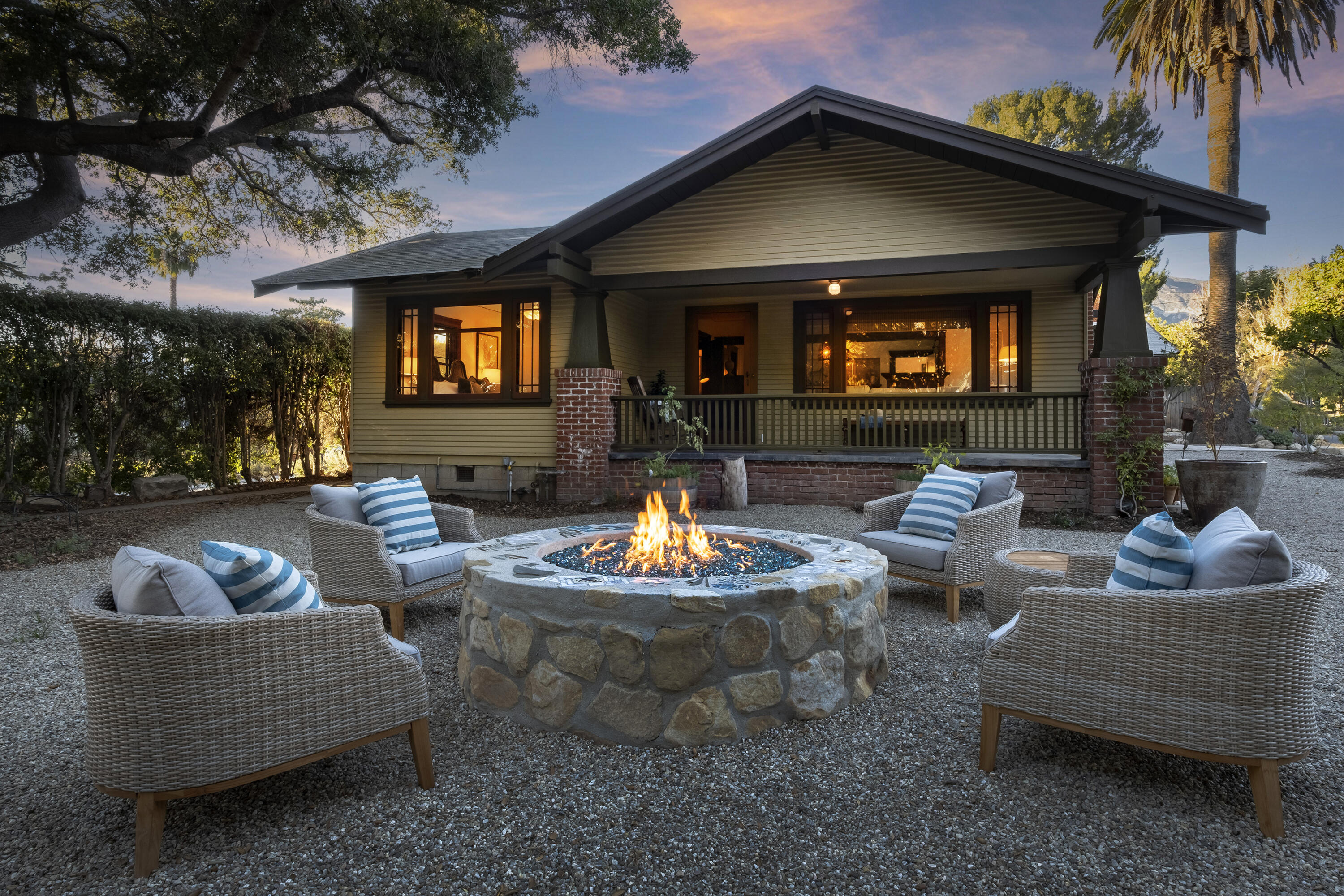a outdoor space with patio couches and a fireplace