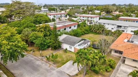 an aerial view of residential houses with outdoor space and street view