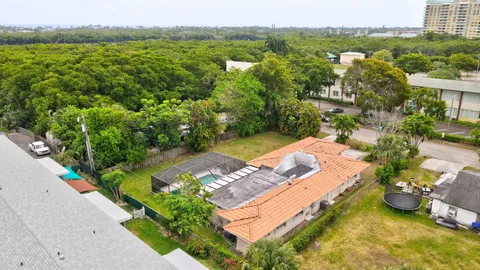 a view of a house with swimming pool and a small yard