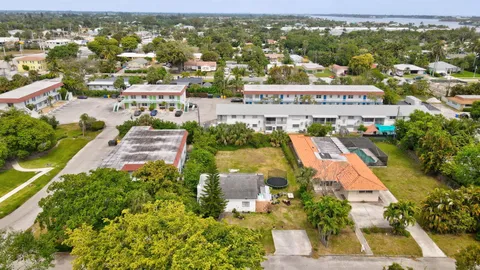 an aerial view of residential houses with outdoor space and parking