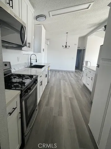 a kitchen with a sink stove and microwave